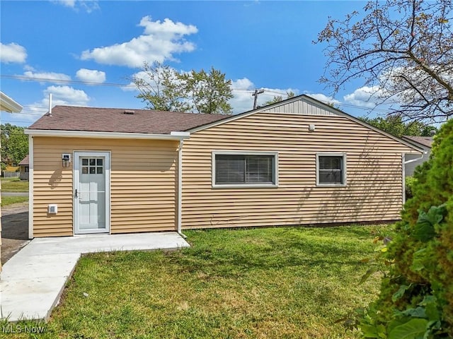 rear view of house with a lawn