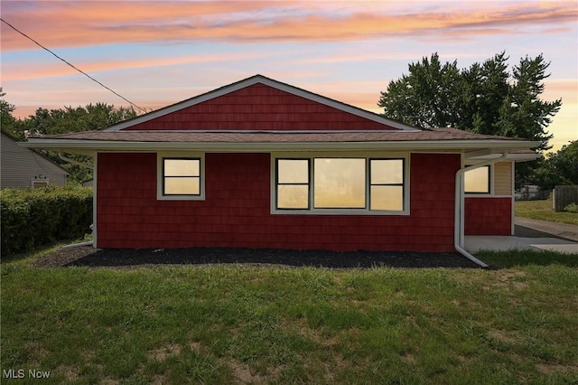 view of side of home featuring a yard