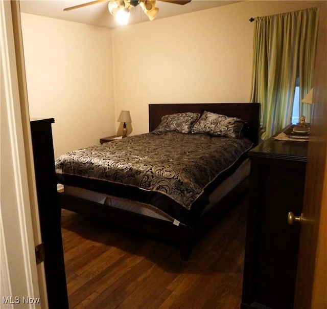 bedroom with ceiling fan and dark wood finished floors