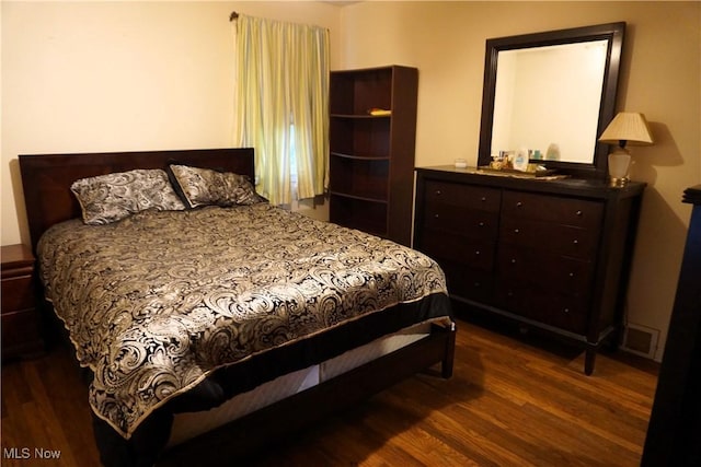 bedroom featuring dark wood-style floors and visible vents