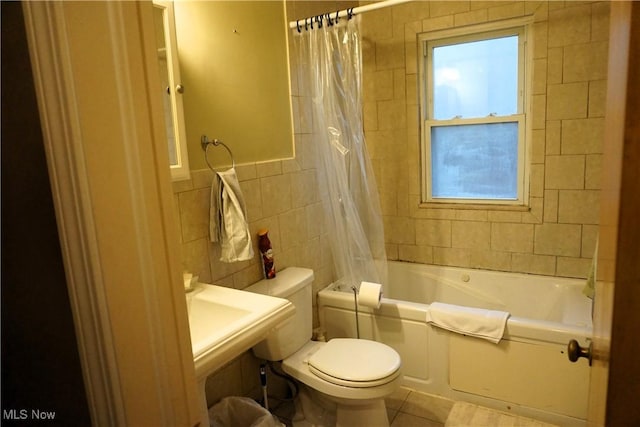 bathroom featuring toilet, tile patterned flooring, tile walls, and shower / tub combo with curtain