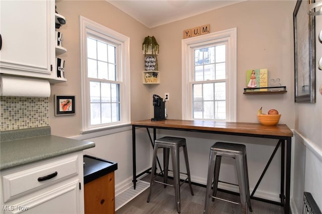 interior space with open shelves, butcher block counters, backsplash, dark wood-type flooring, and white cabinetry