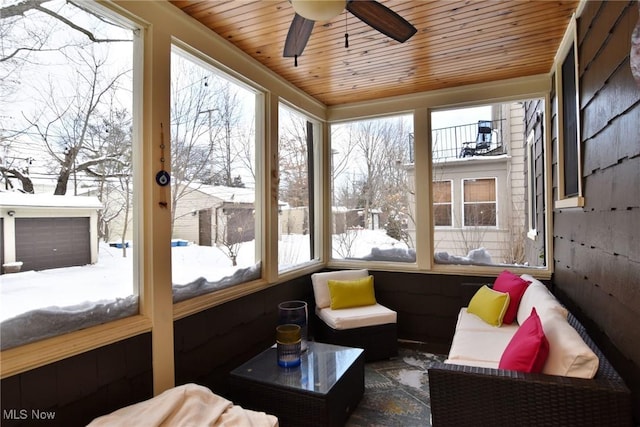 sunroom / solarium featuring wood ceiling, a healthy amount of sunlight, and ceiling fan