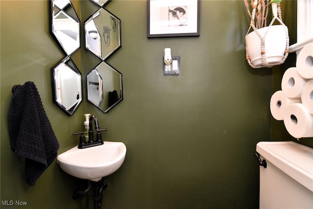 bathroom with toilet and a sink