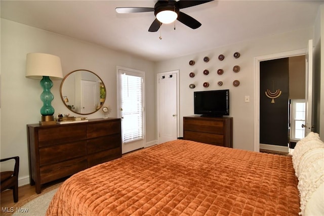 bedroom featuring a ceiling fan and baseboards