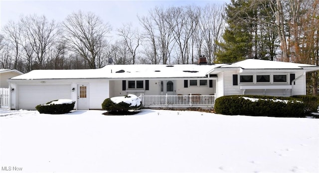 single story home with a chimney and an attached garage