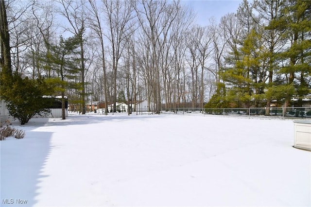 yard layered in snow with fence