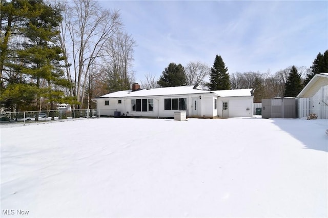 snow covered property featuring fence