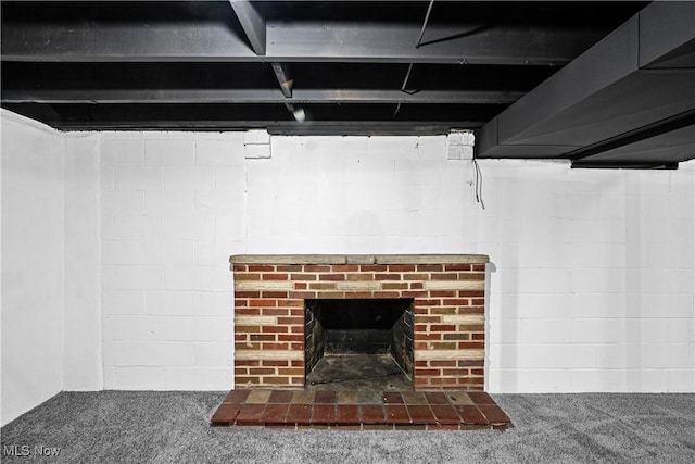 room details featuring carpet and a brick fireplace