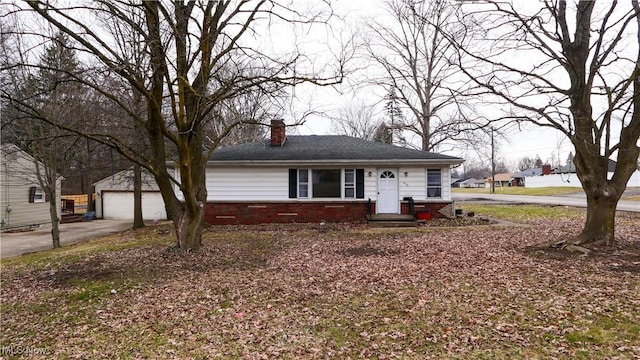 view of front of house with a garage, brick siding, and a chimney