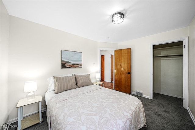 bedroom featuring baseboards, visible vents, dark colored carpet, and a closet