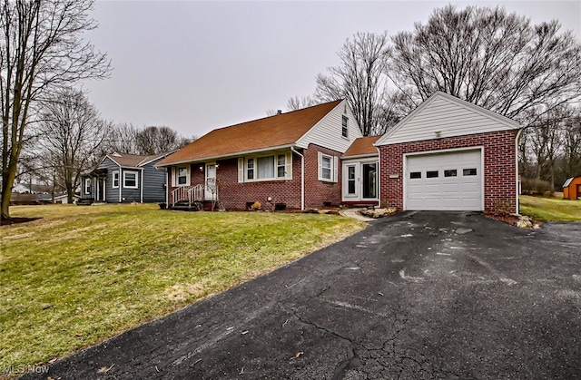 view of front of home featuring a front lawn, brick siding, driveway, and an attached garage