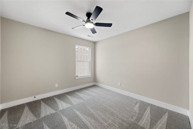 carpeted empty room featuring a ceiling fan, visible vents, and baseboards