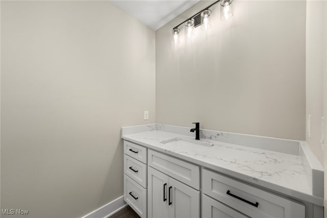 bathroom with vanity and baseboards