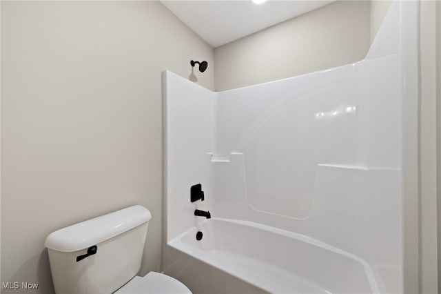 bathroom with washtub / shower combination and toilet