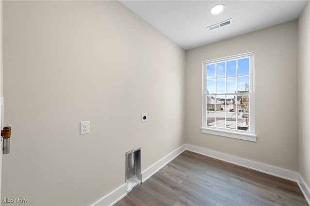 clothes washing area with laundry area, baseboards, visible vents, and electric dryer hookup