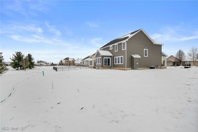 view of snow covered rear of property