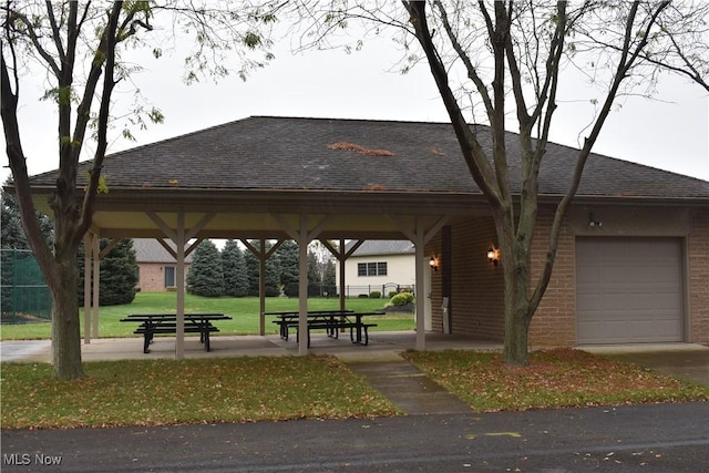 view of community with a garage and a yard
