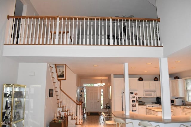 entrance foyer with stairs and a high ceiling