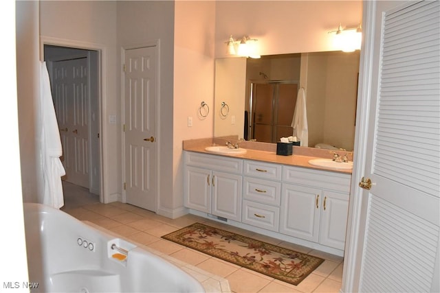 full bath with a stall shower, double vanity, a sink, and tile patterned floors