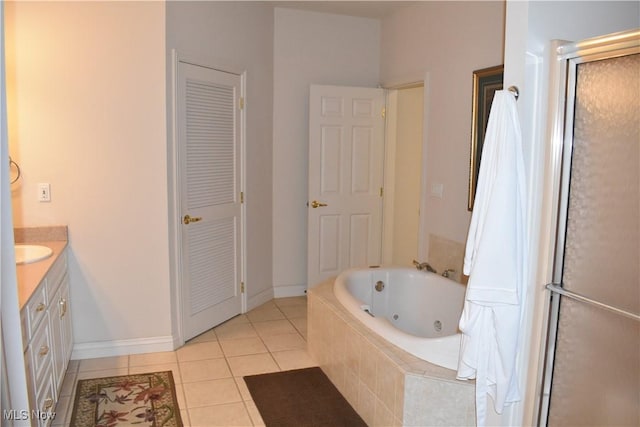 full bathroom with a shower with shower door, vanity, a closet, tile patterned floors, and a whirlpool tub