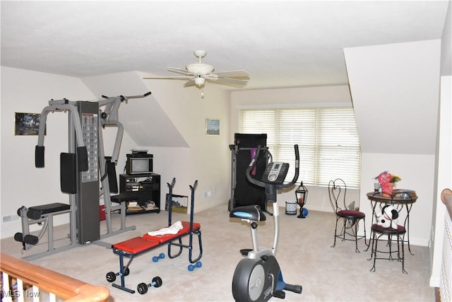 exercise room with a ceiling fan, light colored carpet, and baseboards