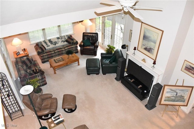 living area featuring light carpet and ceiling fan