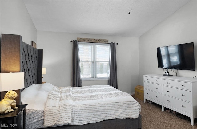 bedroom featuring dark carpet and vaulted ceiling