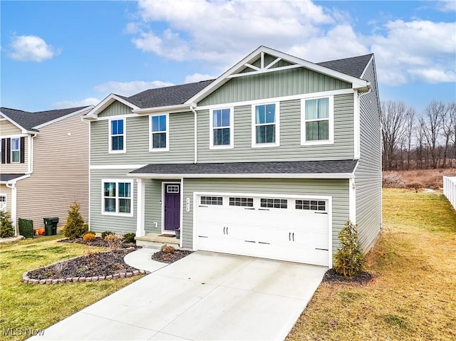 view of front of property with driveway, a shingled roof, a garage, and a front lawn