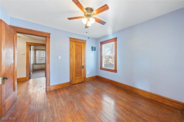 unfurnished bedroom with a ceiling fan, baseboards, and hardwood / wood-style flooring