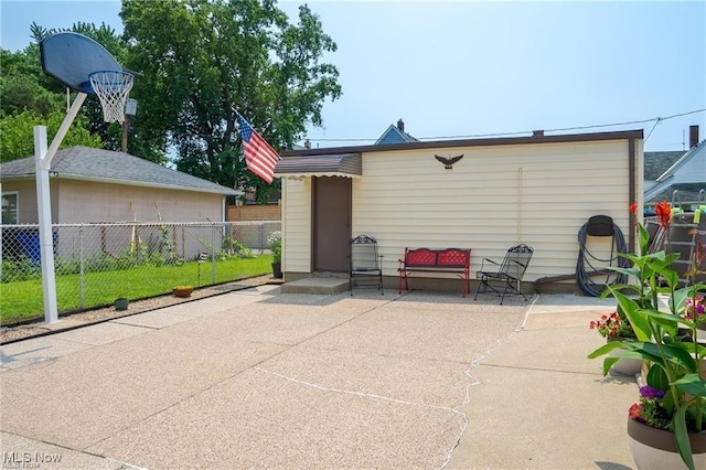 rear view of property with a patio area and fence