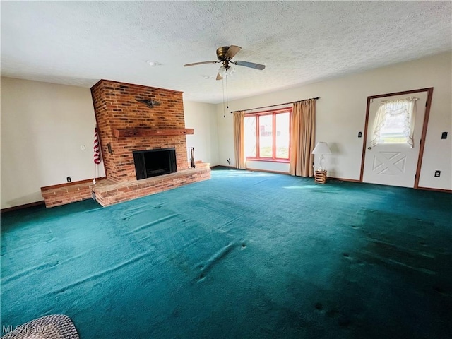 unfurnished living room featuring carpet, a fireplace, ceiling fan, a textured ceiling, and baseboards