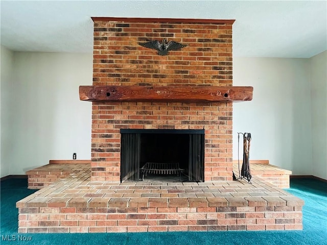 interior details featuring carpet, a fireplace, and baseboards