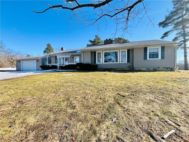 ranch-style house with a garage, driveway, a chimney, and a front yard