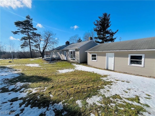 snow covered property featuring a yard