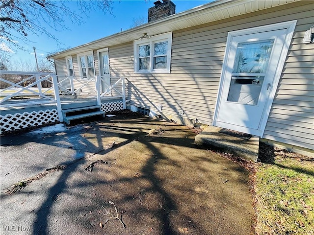 exterior space with a deck and a chimney