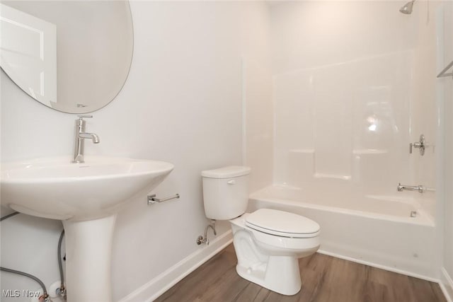 full bathroom with toilet, bathtub / shower combination, baseboards, and wood finished floors