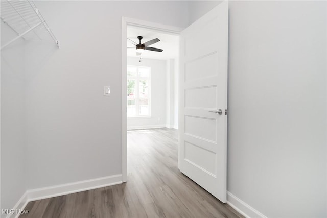 hallway with light wood finished floors and baseboards