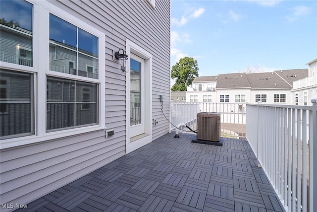 view of patio / terrace with a balcony and central air condition unit