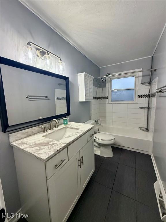 full bathroom featuring visible vents, bathing tub / shower combination, toilet, tile patterned floors, and vanity