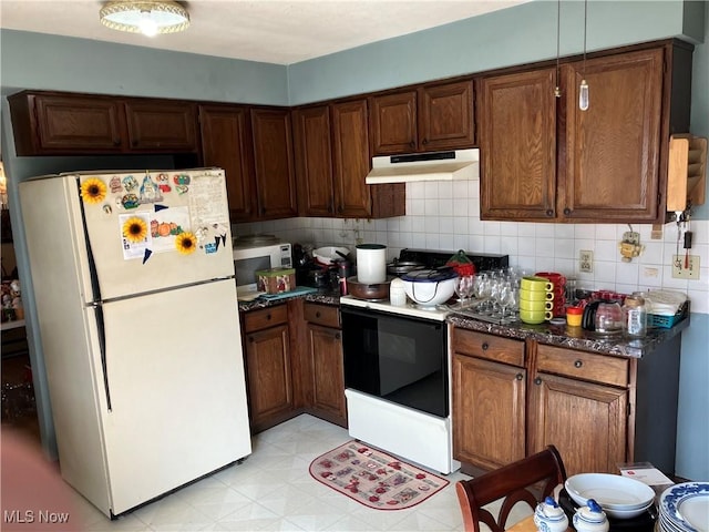 kitchen featuring white appliances, backsplash, and under cabinet range hood