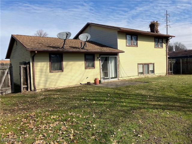 rear view of property with a patio area, fence, and a lawn