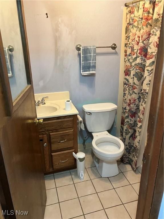 full bathroom with tile patterned flooring, a shower with shower curtain, vanity, and toilet