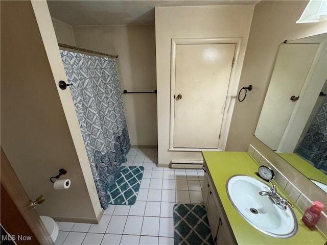 bathroom with baseboards, a shower with shower curtain, toilet, tile patterned flooring, and vanity