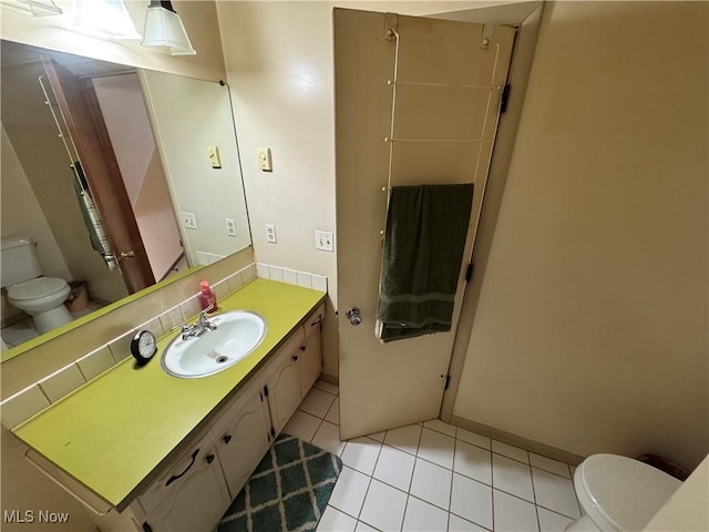 bathroom featuring vanity, toilet, and tile patterned floors