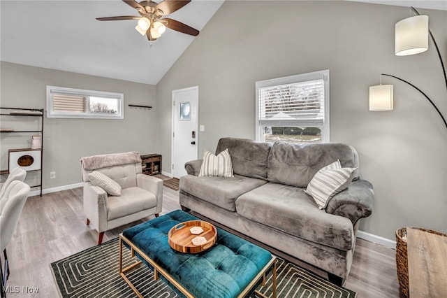 living room featuring high vaulted ceiling, ceiling fan, baseboards, and wood finished floors