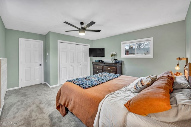 bedroom featuring ceiling fan, a closet, carpet flooring, and baseboards