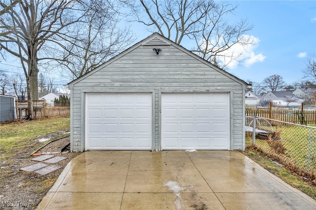 detached garage featuring fence