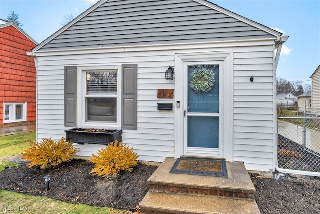 doorway to property featuring fence