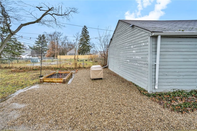 view of yard featuring a vegetable garden and fence